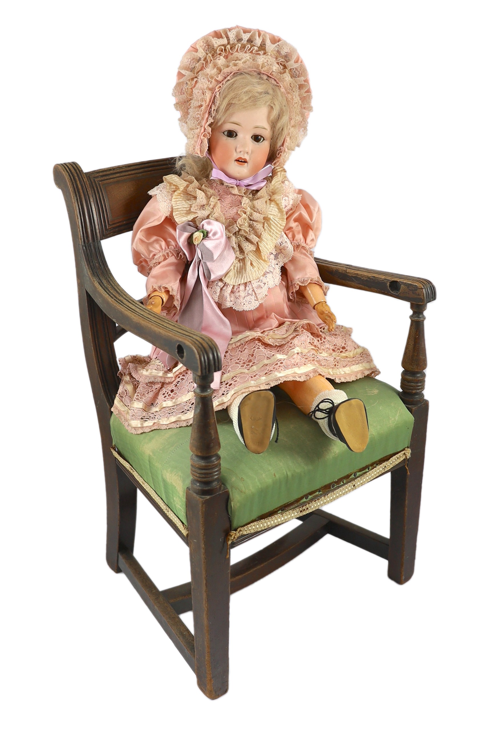 A Heubach Koppelsdorf bisque doll, German, circa 1914, 25in. Please note the chair is for display purposes only.